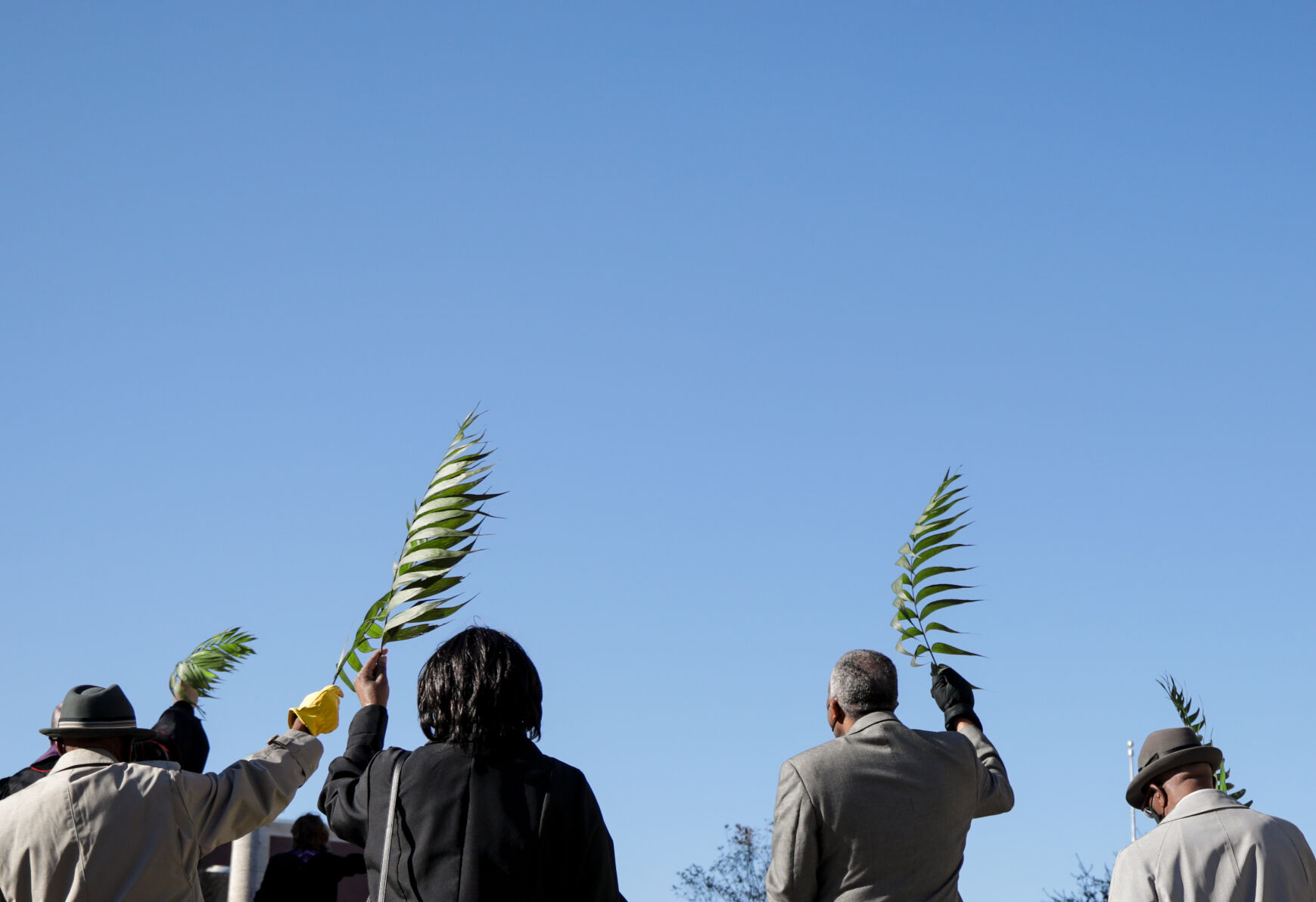 Members of the Second Missionary Baptist Church raise their palm fronds